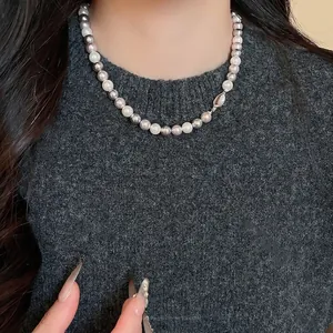 Elegant French-style tri-color pearl beaded necklace on model neck with grey sweater