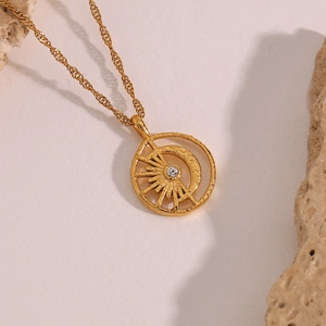 Detail of 18K gold-plated necklace with hollow sun and moon pendant and zircon