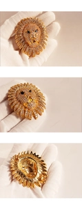 Detailed views of lion head brooch with sparkling clear crystals and blue sapphire eyes