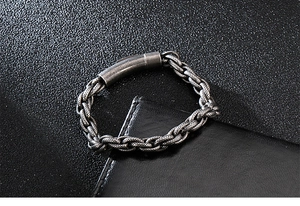 Macro view of vintage silver stainless steel woven chain bracelet with magnetic clasp
