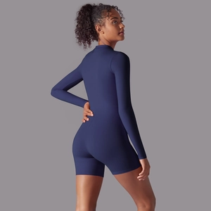 Rear view of navy blue long-sleeve athletic bodysuit showing ergonomic seams and fit