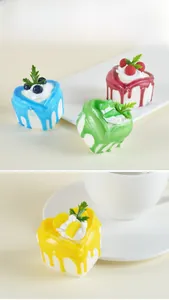 Close-up of heart-shaped simulation cake magnets with cream and fruit toppings in four colors