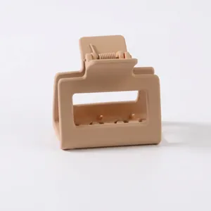 Detail of 5cm square matte hair claw clip in beige with durable metal spring