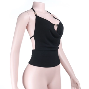 Detail of black halter top featuring gold flower buttons and draped cowl neckline