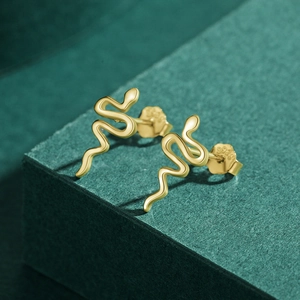 Minimalist gold snake-shaped S925 sterling silver stud earrings on a dark green background