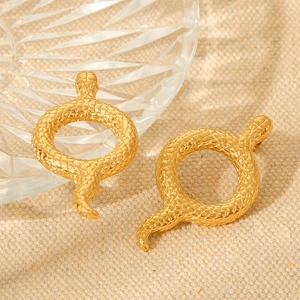 Minimalist 18K gold snake earrings with detailed scale texture on beige fabric background