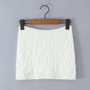 Detailed close-up of white cable knit mini skirt on a hanger showing texture and pattern