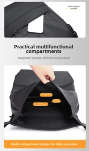 Detail view of black backpack showing internal laptop compartment and multi-pocket layout