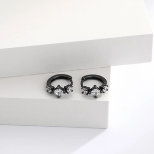 Detailed view of black silver earrings with square zircon crystals on geometric pedestal
