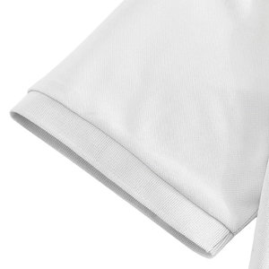 Close-up of white pique knit fabric and ribbed cuff detail on the men's polo shirt