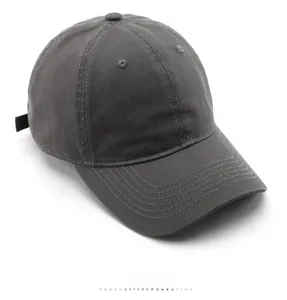 Top view detail of a dark grey washed cotton baseball cap with ventilation eyelets