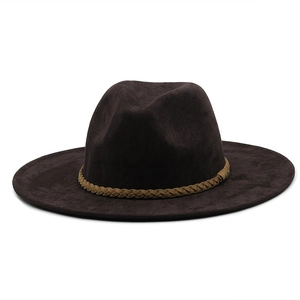 Detail of dark brown suede cowboy hat with braided decorative band and wide flat brim