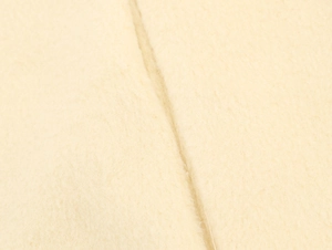Close-up of beige wool texture showing soft fabric fibers and detailed stitching