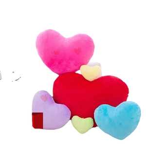 Plush heart-shaped pillows in various colors and sizes on a clean white background