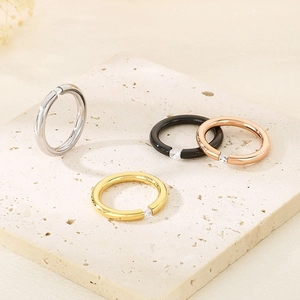 Minimalist 18k gold plated titanium steel rings with zircon on a stone surface
