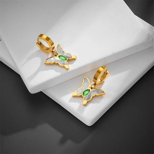 Gold butterfly earrings with green zircon and white shell inlay on stone pedestals