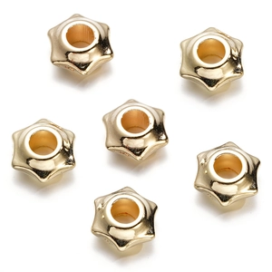Detail shot of golden hexagram star spacer beads with central holes for jewelry DIY