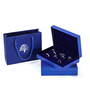 Royal blue jewelry gift set with shopping bag and ring box featuring 7 silver rings