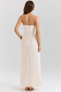 Rear view of an elegant cream strapless pleated maxi dress with hidden zipper detail