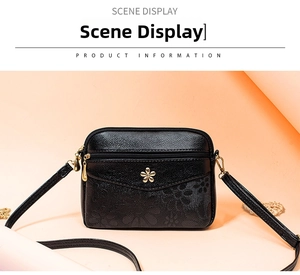 Black leather crossbody bag for women, elegant shoulder purse with flower hardware decor.