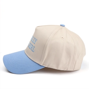 Detail view of ALLY GIRL embroidery on a beige and light blue contrast baseball cap