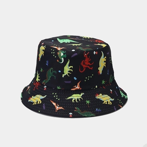 Detailed view of colorful cartoon dinosaur prints on black cotton fisherman hat fabric