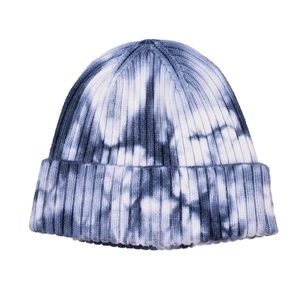 Detail of blue and white tie-dye knit beanie showing ribbed texture and wide fold-over cuff