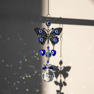 Blue Evil Eye butterfly crystal suncatcher hanging with rainbow prism light effect