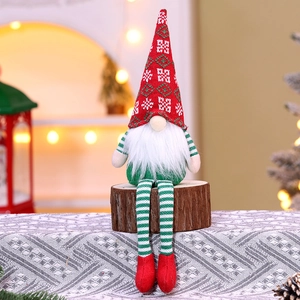 Detail of Christmas gnome plush doll with striped knit long legs on a rustic wooden stump