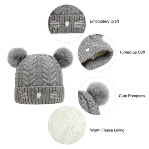 Cute grey knit baby beanie with cat whiskers, faux fur pom-poms and warm fleece lining