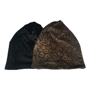 Leopard print plush beanie hats in black and dark brown with soft velvet texture