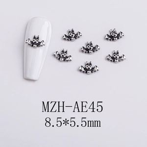 Detailed view of silver bat nail charms with dimensions 8.5x5.5mm for Halloween DIY