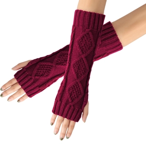 Detail of burgundy diamond-pattern knit fingerless gloves showing textured cable stitching