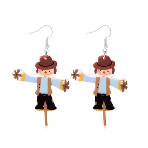 Detailed view of handmade scarecrow acrylic earrings with colorful festive outfit details