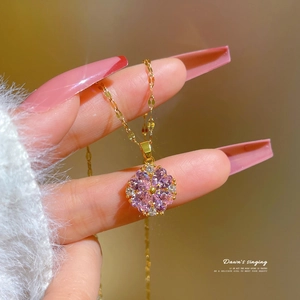 Elegant gold titanium steel necklace featuring a flower pendant with pink and clear crystals