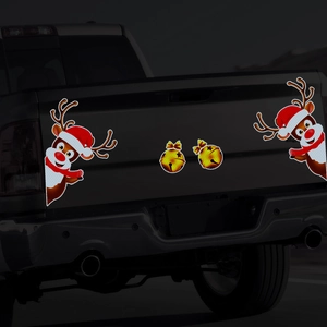 Close-up of reflective reindeer and bell magnets on a black truck for Christmas decor