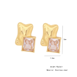 Detailed view of rectangular clear gem set in irregular gold-tone stainless steel earrings