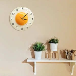 Modern minimalist fried egg wall clock for kitchen decor with 3D design on beige wall