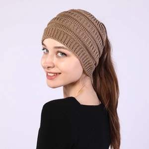 Detail view of brown knitted ponytail beanie with open top for women hairstyle