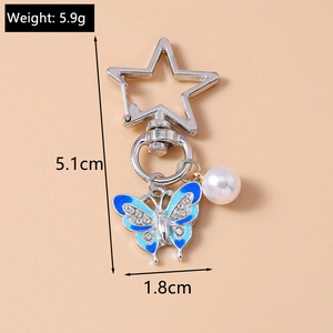 Detailed view of rhinestone butterfly keychain with dimensions and weight data
