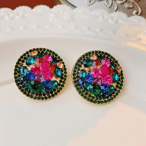 Detailed macro view of vintage round clip earrings with colorful inlaid rhinestones