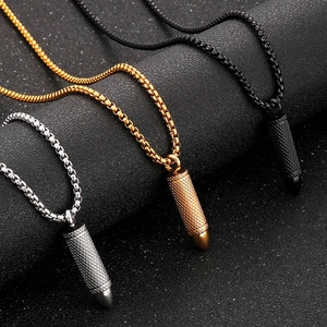 Detailed macro view of bullet pendants with knurled textures in black gold and silver