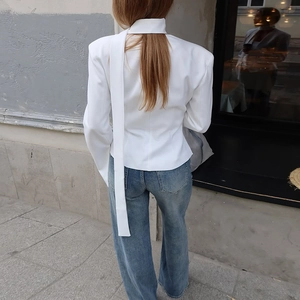 Detail of white blazer jacket with stylish back lace-up design and slim fit cut