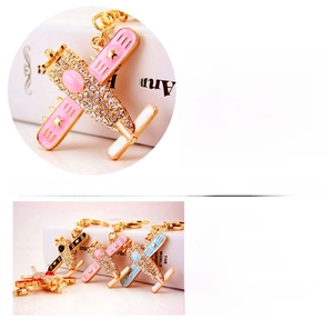 Detailed macro view of colorful rhinestone helicopter keychains with size dimensions