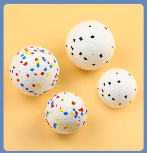 Detailed macro view of textured high-elasticity pet toy balls on bright yellow backdrop