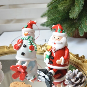 Handcrafted Santa and Snowman resin ornaments on a gold mirror tray for Christmas decor