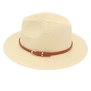 Close-up of cream Panama hat straw texture with brown leather buckle strap detail