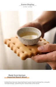 Close-up of hand-sanded German beech wood biscuit-shaped coaster with soft rounded edges