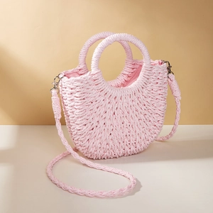 Close-up of pink crescent straw woven handbag with matching rope shoulder strap