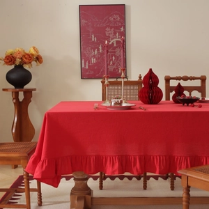 Close-up of red cotton linen tablecloth featuring decorative lotus leaf ruffled edges